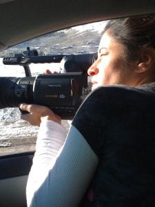 Shanele shooting out of a car window