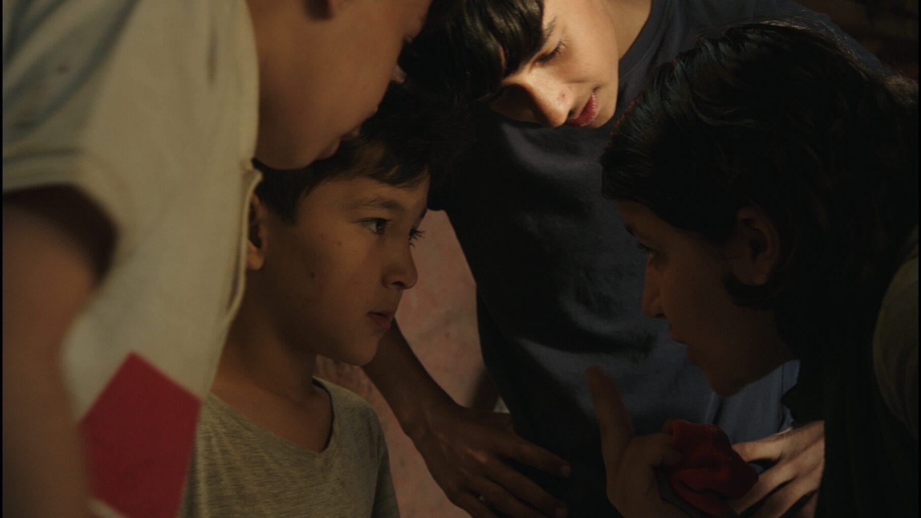 Ghazaal and a few young boys from the refugee camp are having an intense discussion surrounding the sale of some socks.