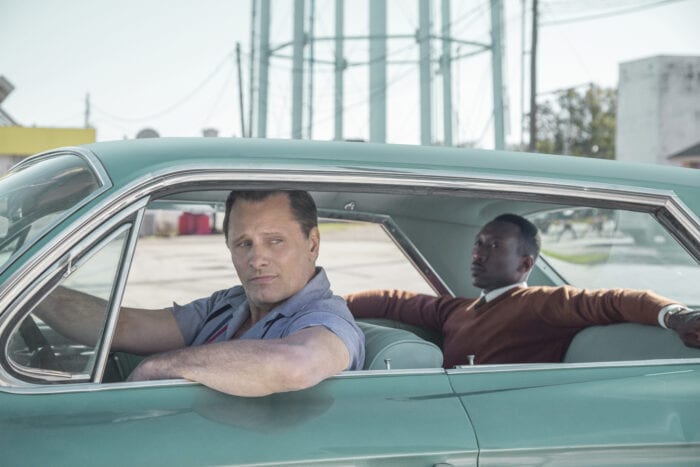 A still from Green Book featuring the two main characters in a vintage blue car.