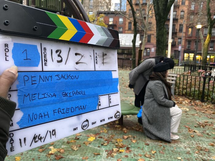 An on-set picture of a clapboard with Penny and Melissa's names on it.
